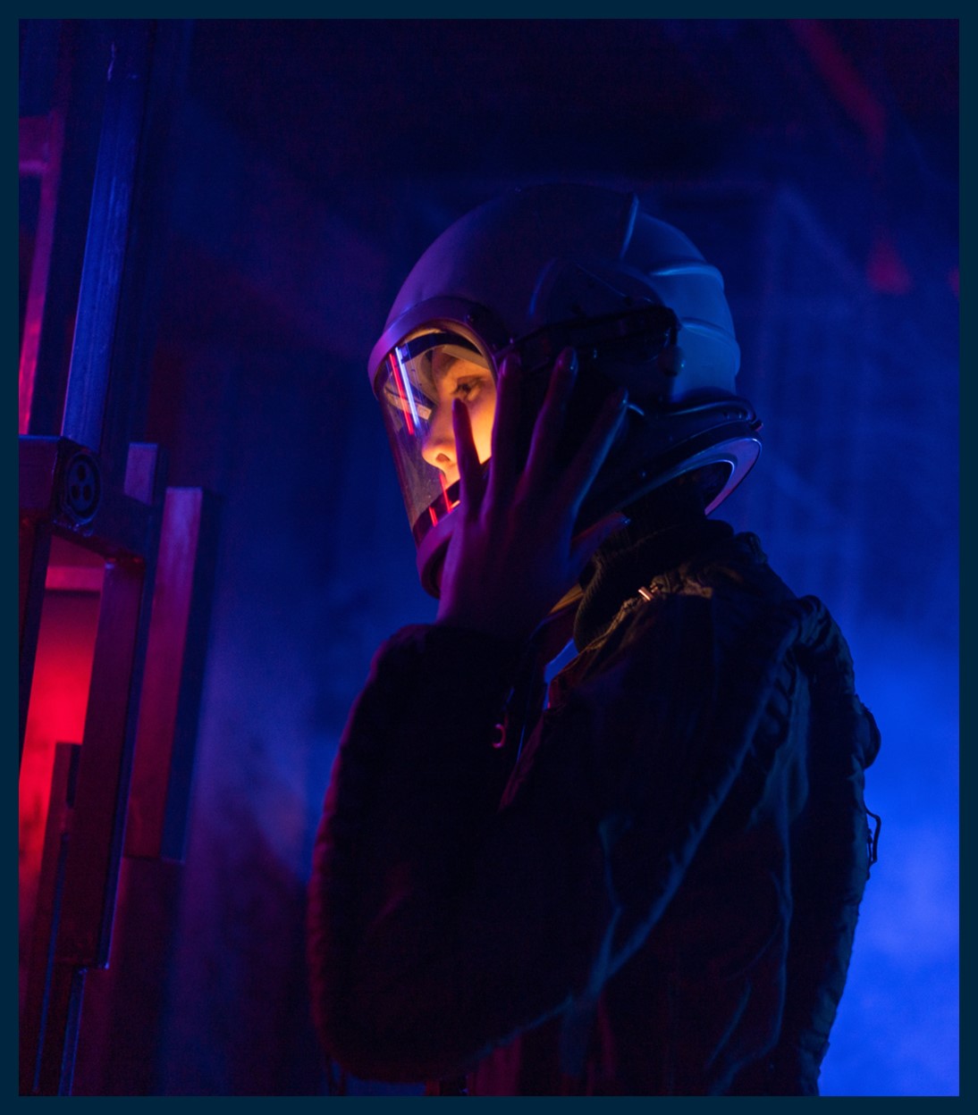 A person with a helmet on in dark environment.